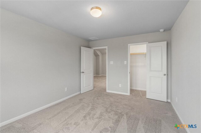 416 Stellar Wind Dr, Georgetown, TX 78628 - unfurnished bedroom featuring a spacious closet and light colored carpet