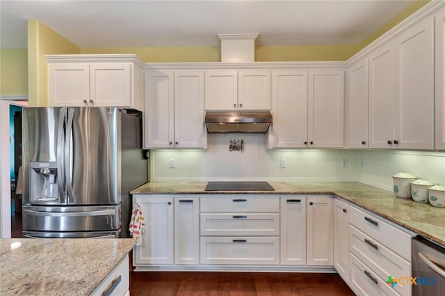 kitchen featuring under cabinet range hood, stainless steel appliances, light stone countertops, and white cabinets