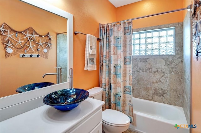 bathroom featuring vanity, toilet, and shower / bathtub combination with curtain