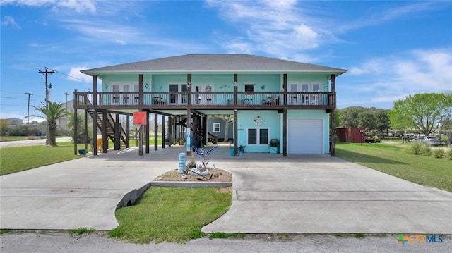 view of front of home featuring a front lawn, stairway, concrete driveway, covered porch, and a carport