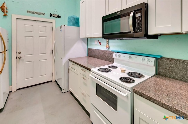 kitchen featuring white appliances, concrete flooring, and white cabinets