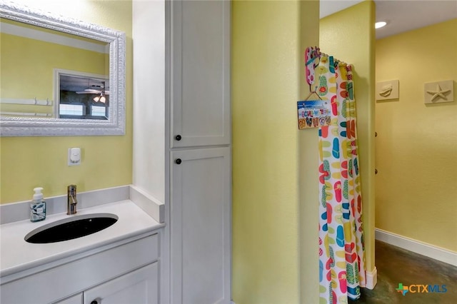 bathroom featuring baseboards and vanity