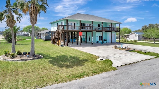 view of front of home featuring stairs, a carport, concrete driveway, and a front lawn