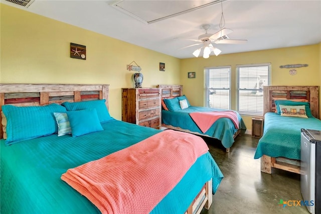 bedroom featuring visible vents, concrete flooring, ceiling fan, and attic access