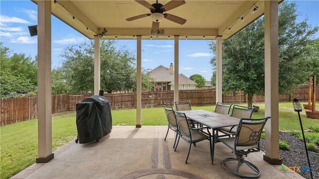 view of patio with area for grilling, ceiling fan, and outdoor dining space