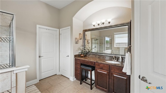 bathroom featuring a shower stall, vanity, tile patterned floors, and baseboards