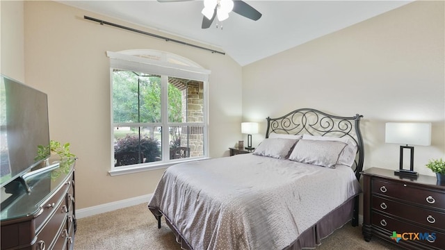 carpeted bedroom featuring lofted ceiling, baseboards, and a ceiling fan