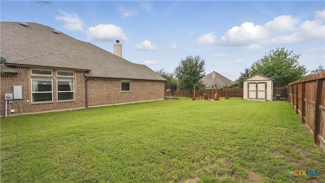 view of yard featuring a shed and an outbuilding