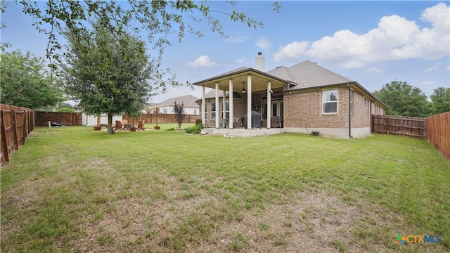 back of property with a chimney, brick siding, and a sunroom