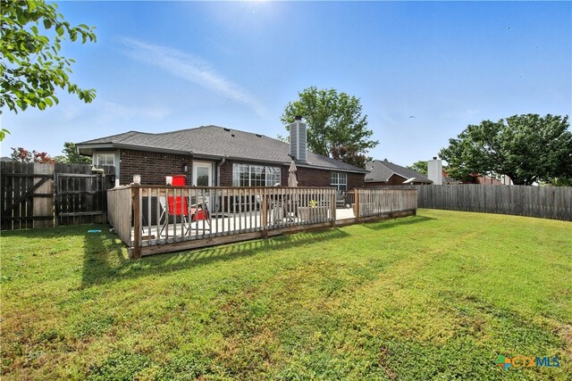 604 Totem Trl, Harker Heights, TX 76548 - rear view of house with brick siding, a fenced backyard, a chimney, and a deck