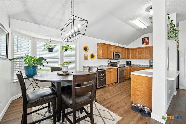 604 Totem Trl, Harker Heights, TX 76548 - kitchen featuring appliances with stainless steel finishes, wood finished floors, a textured ceiling, light countertops, and brown cabinets