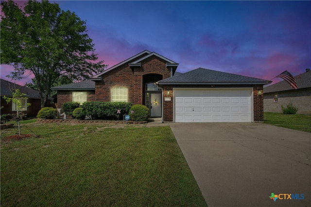 604 Totem Trl, Harker Heights, TX 76548 - view of front of home with brick siding, a front yard, driveway, and an attached garage