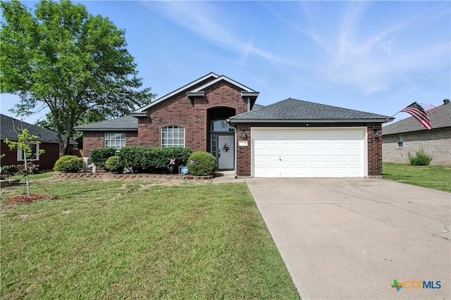 604 Totem Trl, Harker Heights, TX 76548 - view of front of home with brick siding, an attached garage, and a front yard