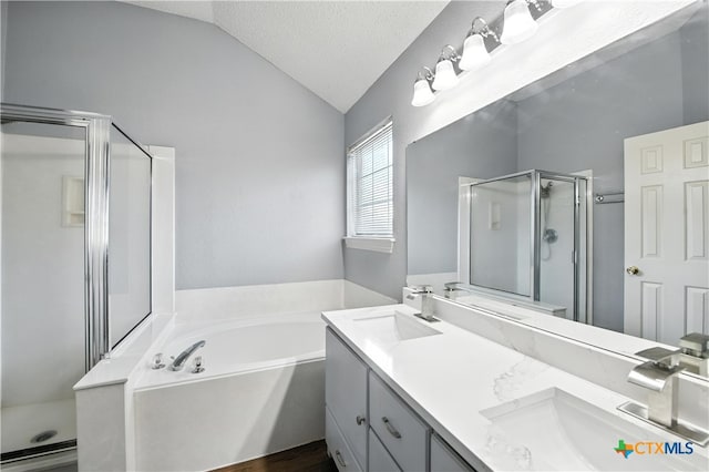 604 Totem Trl, Harker Heights, TX 76548 - full bath with a shower stall, vaulted ceiling, double vanity, a bath, and a textured ceiling