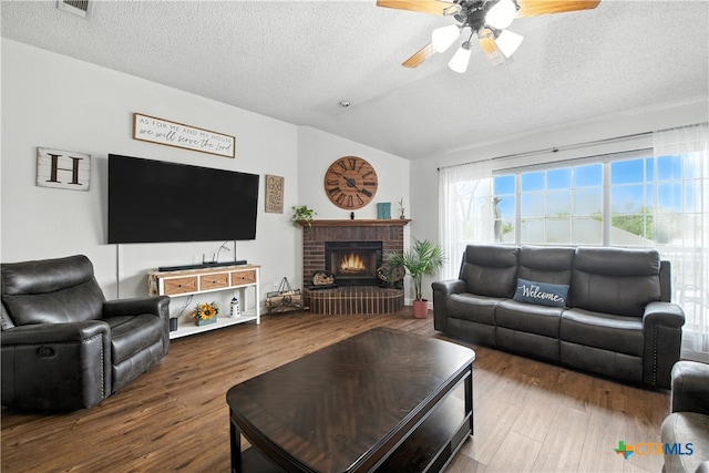 604 Totem Trl, Harker Heights, TX 76548 - living room featuring vaulted ceiling, a textured ceiling, ceiling fan, wood finished floors, and a fireplace