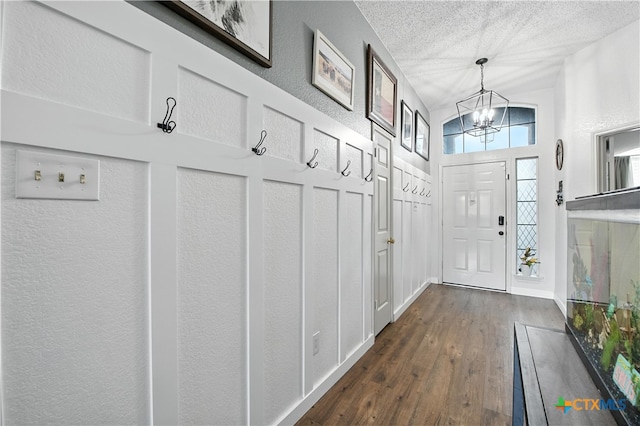 604 Totem Trl, Harker Heights, TX 76548 - mudroom with a chandelier, a textured ceiling, dark wood-style flooring, and a towering ceiling