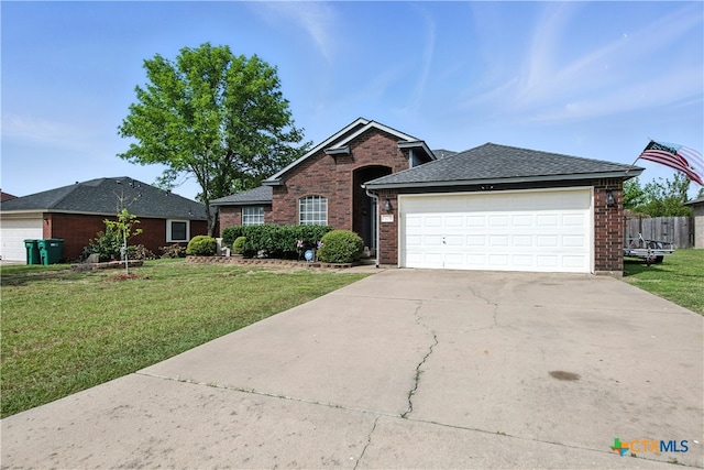 604 Totem Trl, Harker Heights, TX 76548 - view of front of home with brick siding, a front yard, concrete driveway, and an attached garage