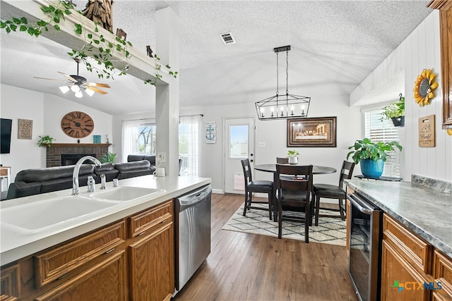 604 Totem Trl, Harker Heights, TX 76548 - kitchen with stainless steel dishwasher, lofted ceiling, wine cooler, brown cabinets, and a textured ceiling