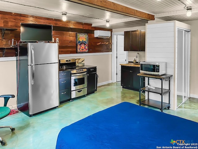 kitchen featuring dark brown cabinets, a wall mounted AC, beam ceiling, and appliances with stainless steel finishes