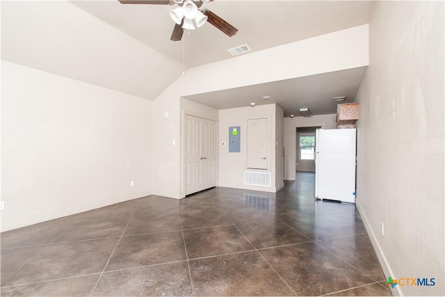 1219 Honor Ln, Temple, TX 76501 - empty room featuring a ceiling fan, electric panel, baseboards, vaulted ceiling, and concrete floors