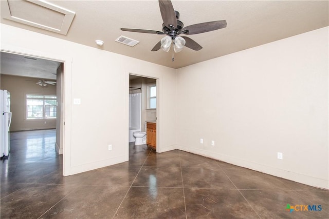 1219 Honor Ln, Temple, TX 76501 - unfurnished room featuring baseboards, ceiling fan, finished concrete floors, and attic access