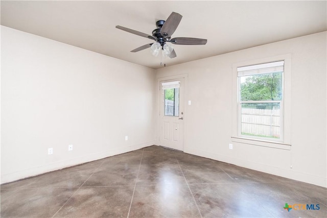 1219 Honor Ln, Temple, TX 76501 - unfurnished room with concrete flooring, baseboards, and ceiling fan