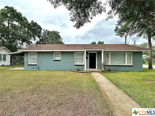 ranch-style house with a carport and a front lawn