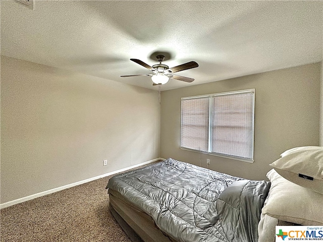 bedroom featuring ceiling fan, a textured ceiling, and carpet flooring