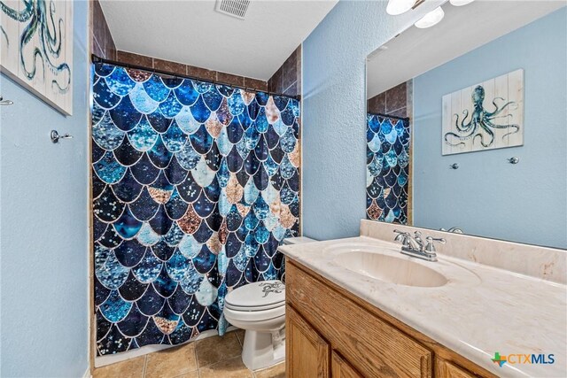 3704 Dewitt County Ct, Killeen, TX 76549 - full bath with a textured wall, tile patterned flooring, toilet, a shower with shower curtain, and vanity