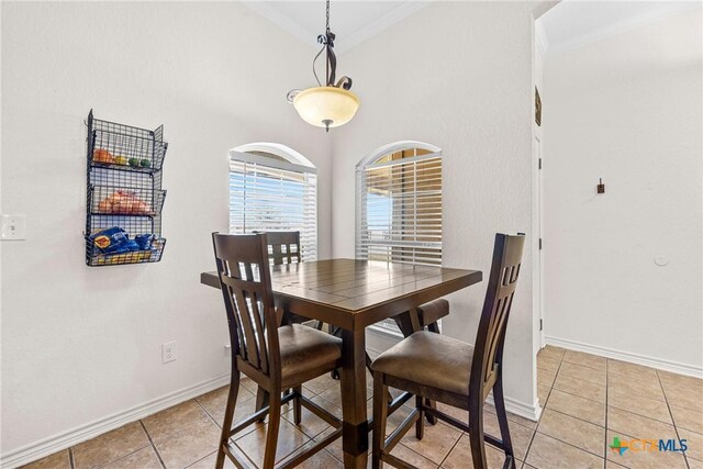 3704 Dewitt County Ct, Killeen, TX 76549 - dining space with light tile patterned floors, baseboards, ornamental molding, and a towering ceiling