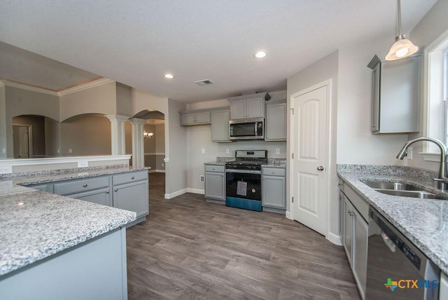 142 Merion Ln, La Vernia, TX 78121 - kitchen featuring appliances with stainless steel finishes, arched walkways, ornate columns, a sink, and gray cabinets