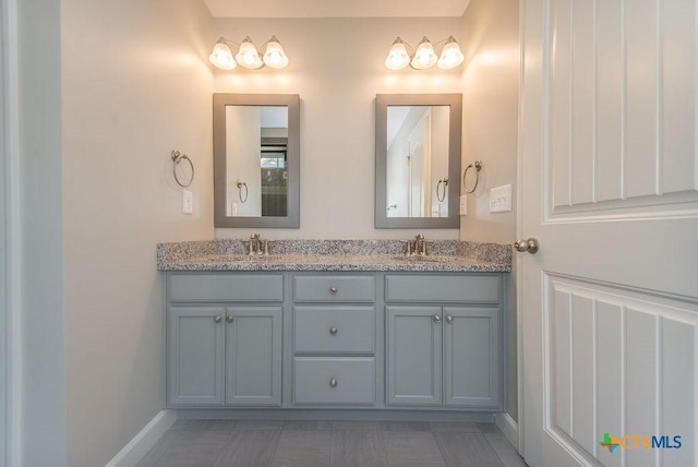 142 Merion Ln, La Vernia, TX 78121 - full bathroom featuring double vanity and baseboards