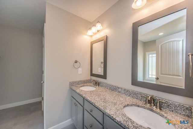 142 Merion Ln, La Vernia, TX 78121 - full bathroom with double vanity and baseboards