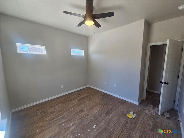 unfurnished bedroom featuring ceiling fan, baseboards, and wood finished floors