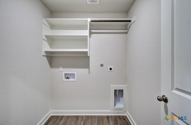 clothes washing area with baseboards, laundry area, hookup for a washing machine, wood finished floors, and hookup for an electric dryer