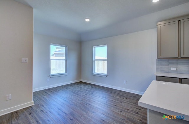 interior space with dark wood-style floors, recessed lighting, and baseboards