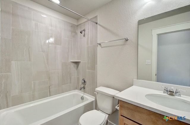 full bath featuring vanity, toilet, tub / shower combination, and a textured wall