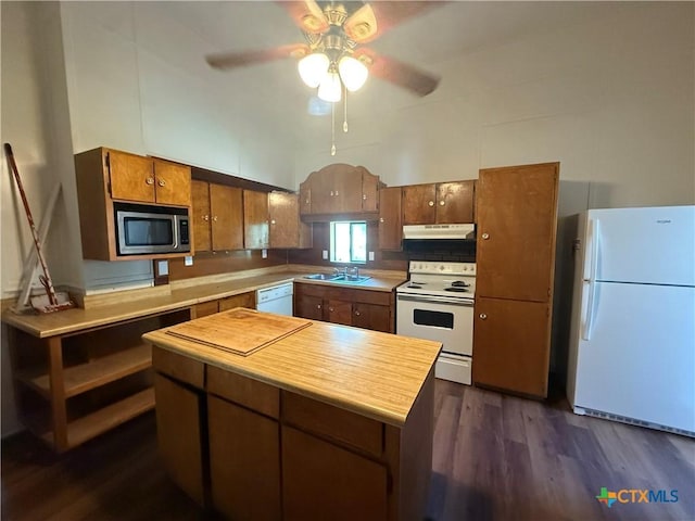 184 3rd St, Maxwell, TX 78656 - kitchen with white appliances, under cabinet range hood, ceiling fan, dark wood-type flooring, and light countertops