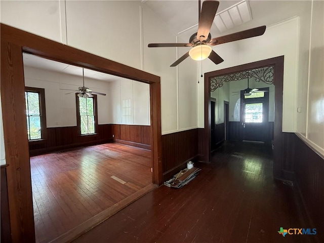 184 3rd St, Maxwell, TX 78656 - interior space featuring ceiling fan, dark wood finished floors, plenty of natural light, a wainscoted wall, and high vaulted ceiling