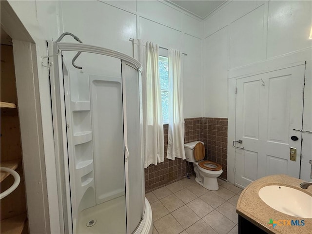 184 3rd St, Maxwell, TX 78656 - bathroom with tile patterned floors, a stall shower, tile walls, vanity, and crown molding