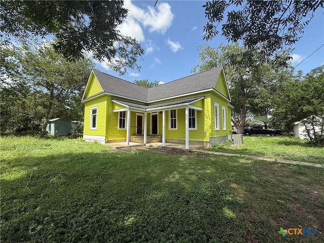 184 3rd St, Maxwell, TX 78656 - view of front of house with a shed, a front lawn, and roof with shingles