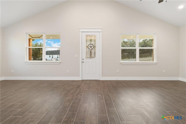 unfurnished living room featuring sink and high vaulted ceiling