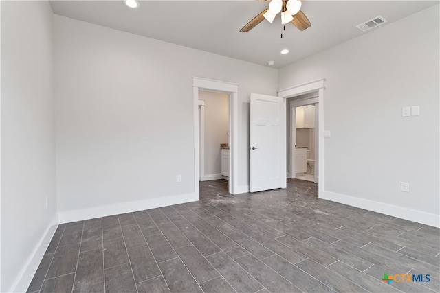 spare room with ceiling fan and dark wood-type flooring