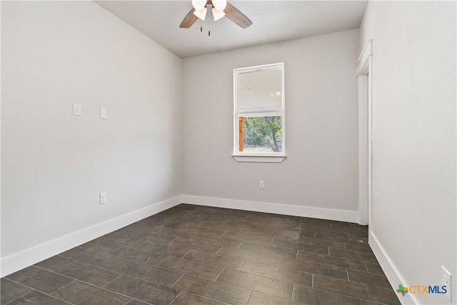 spare room featuring ceiling fan and dark hardwood / wood-style flooring