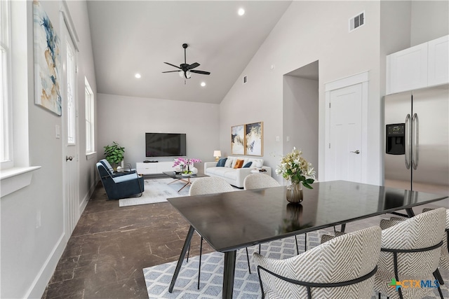 dining space featuring ceiling fan and high vaulted ceiling