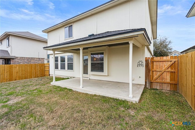 rear view of property with a patio area and a lawn