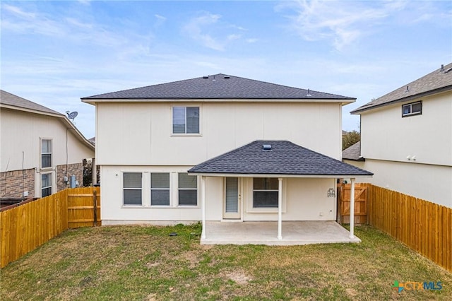 rear view of property featuring a lawn and a patio