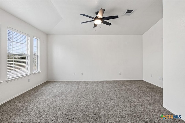 carpeted empty room with ceiling fan and vaulted ceiling