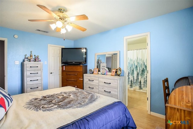 bedroom with visible vents, a ceiling fan, and light wood-style floors