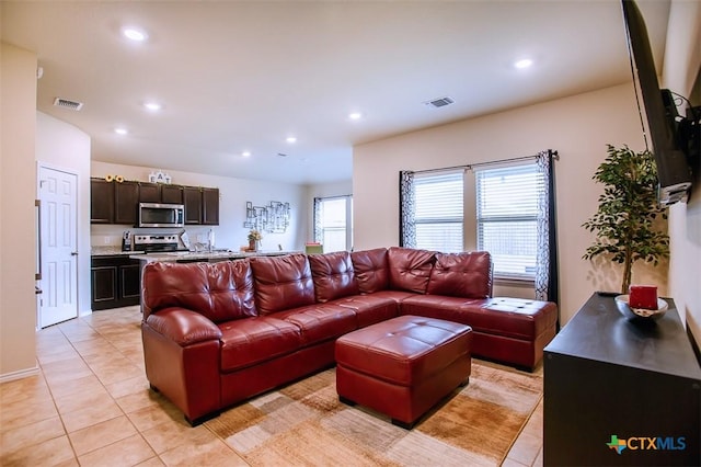 living room with recessed lighting, visible vents, and light tile patterned floors